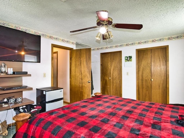 56 Gatehouse Dr, Fall River, MA 02720 - bedroom with two closets, a textured ceiling, and a ceiling fan