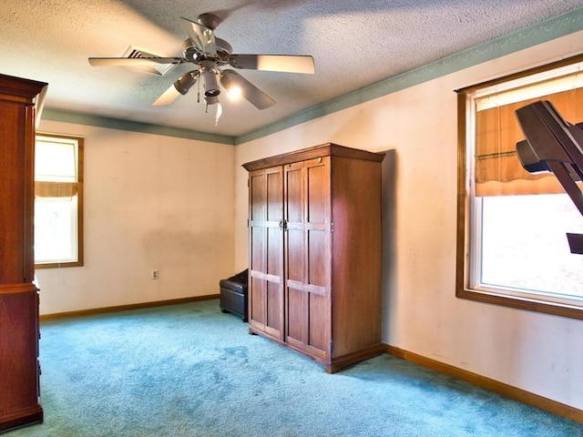 56 Gatehouse Dr, Fall River, MA 02720 - unfurnished bedroom featuring light colored carpet, baseboards, a textured ceiling, and ceiling fan