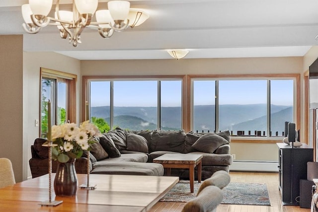 421 Legate Hill Rd, Charlemont, MA 01339 - living room featuring a baseboard radiator, a chandelier, a mountain view, and light wood-style flooring