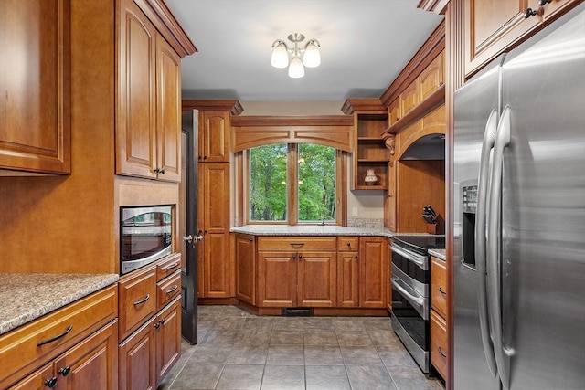 421 Legate Hill Rd, Charlemont, MA 01339 - kitchen with stainless steel appliances, brown cabinets, light stone countertops, and a chandelier