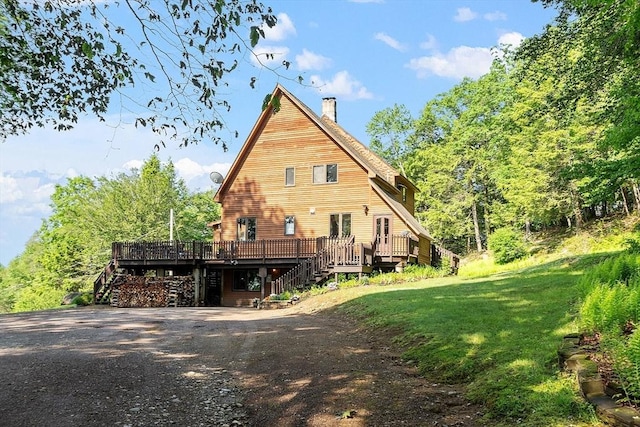 421 Legate Hill Rd, Charlemont, MA 01339 - back of property featuring stairs, a deck, a chimney, a lawn, and driveway