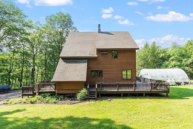 421 Legate Hill Rd, Charlemont, MA 01339 - rear view of property featuring an exterior structure, a deck, roof with shingles, an outbuilding, and a lawn