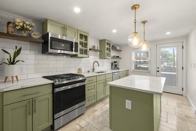 kitchen with green cabinets, open shelves, stainless steel appliances, a sink, and stone tile floors