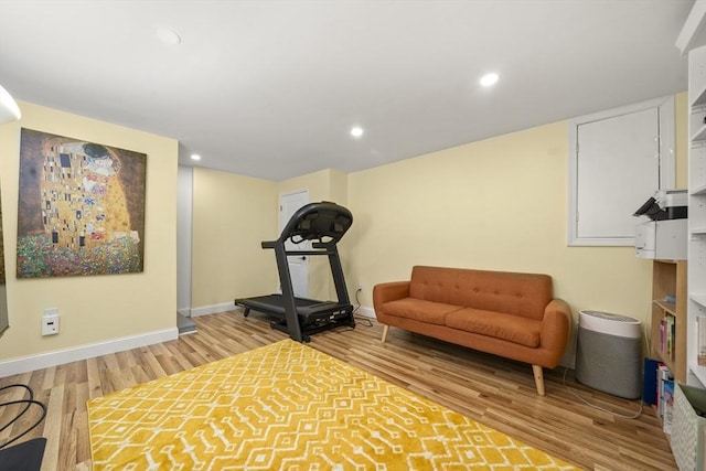 workout room with wood finished floors, baseboards, and recessed lighting