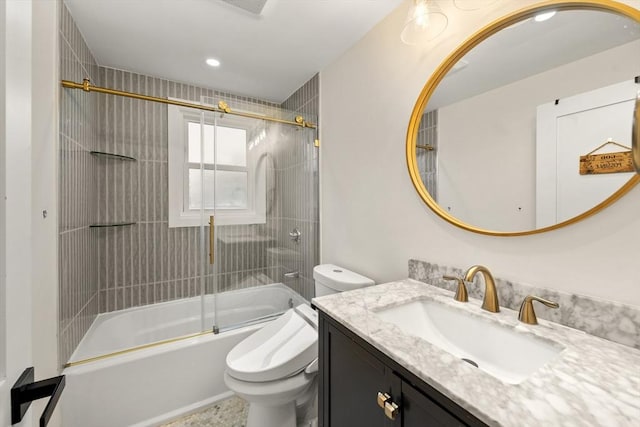 bathroom with toilet, vanity, and shower / bath combination with glass door