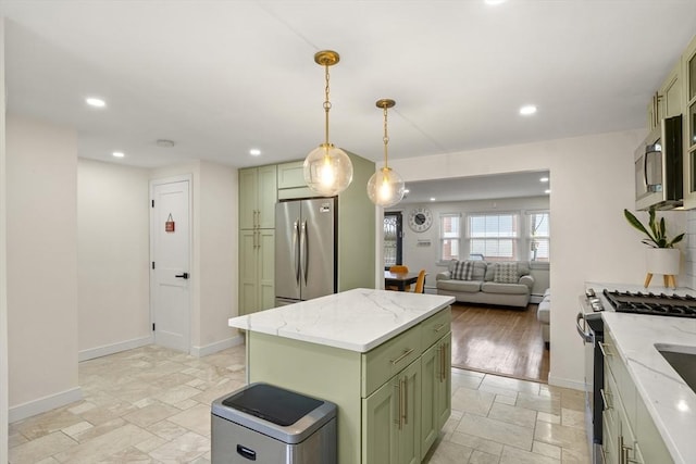 kitchen with green cabinets, appliances with stainless steel finishes, stone tile flooring, baseboards, and recessed lighting