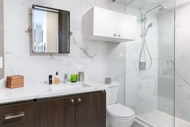 bathroom featuring toilet, a marble finish shower, vanity, and decorative backsplash