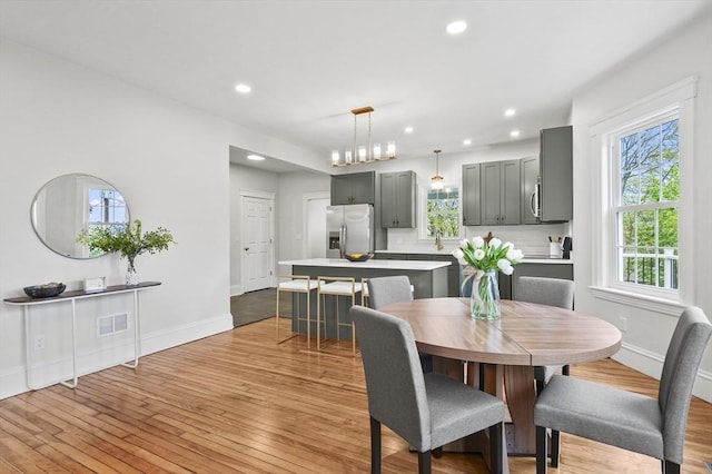 dining room featuring light wood-style floors, recessed lighting, and baseboards