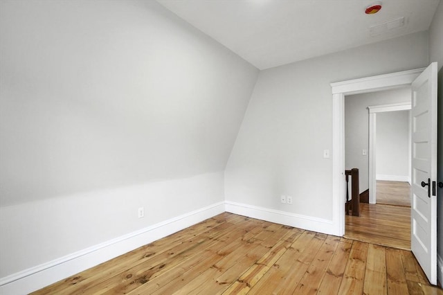 spare room featuring light wood-style flooring and baseboards