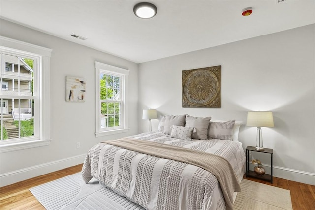 bedroom with baseboards and wood finished floors