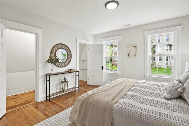 bedroom featuring wood finished floors and baseboards