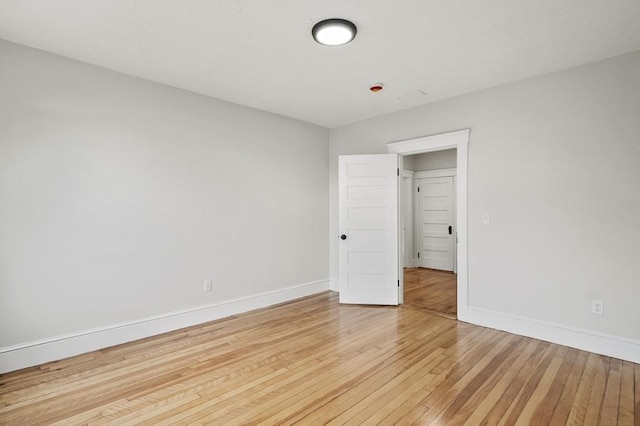 unfurnished bedroom featuring light wood finished floors and baseboards