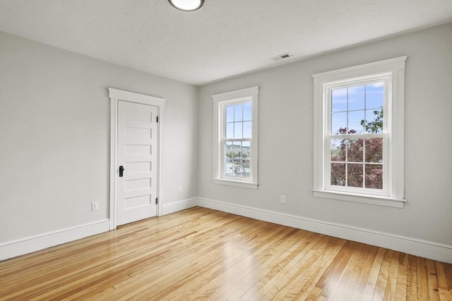 empty room with light wood-style flooring and baseboards