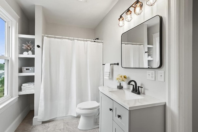 bathroom with toilet, vanity, and a shower with shower curtain