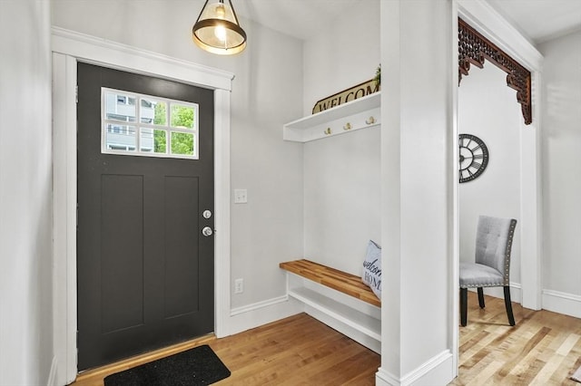 mudroom with wood finished floors and baseboards