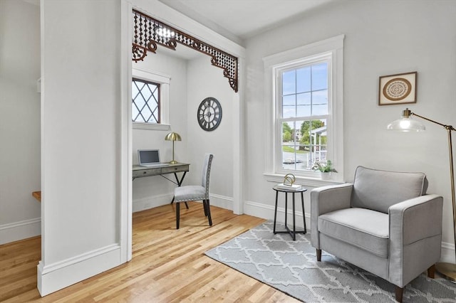 living area with wood finished floors and baseboards