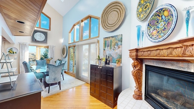 living room featuring a towering ceiling and light hardwood / wood-style flooring