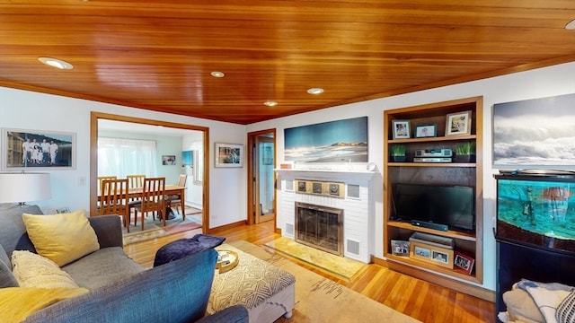 living room featuring wood ceiling, light hardwood / wood-style flooring, and a fireplace