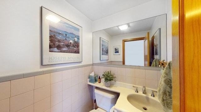 bathroom featuring tile walls and vanity