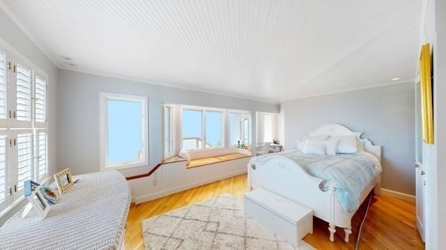 bedroom featuring baseboards and wood finished floors