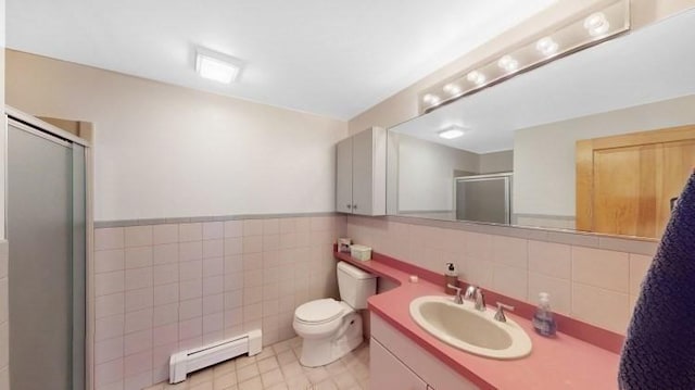 bathroom featuring toilet, a stall shower, tile walls, a baseboard radiator, and vanity