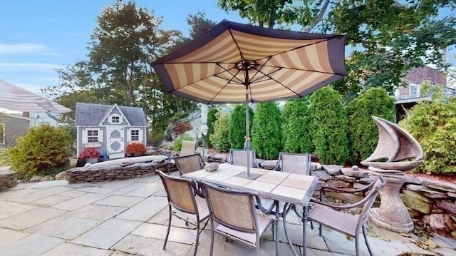 view of patio / terrace featuring an outbuilding