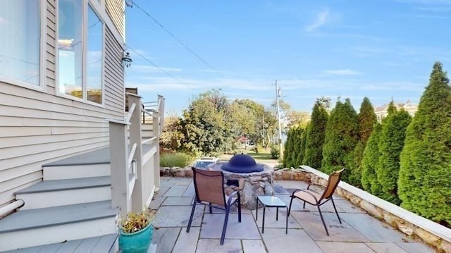 view of patio / terrace featuring outdoor dining space and stairs