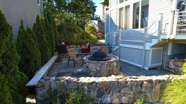 view of patio / terrace featuring an outdoor fire pit