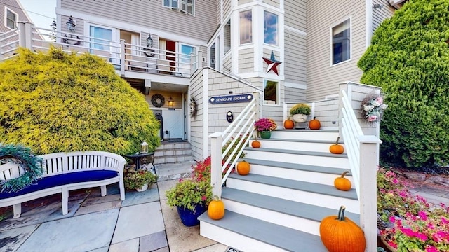 view of exterior entry featuring a balcony