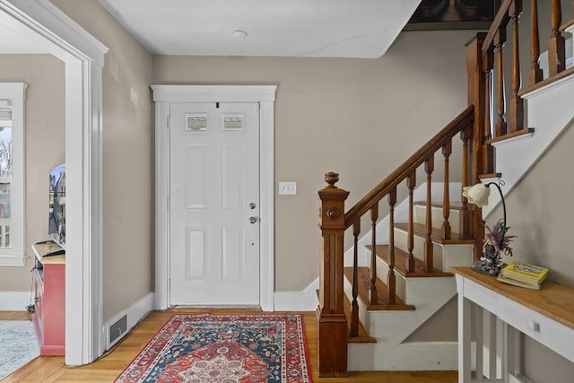 foyer entrance with light hardwood / wood-style flooring