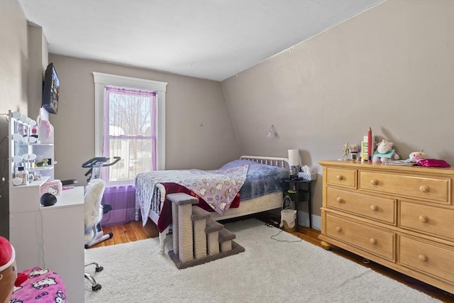 bedroom with light hardwood / wood-style flooring and vaulted ceiling