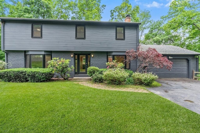 41 Harvey Ln, Westborough, MA 01581 - view of front of home with a chimney, a front yard, asphalt driveway, a garage, and brick siding