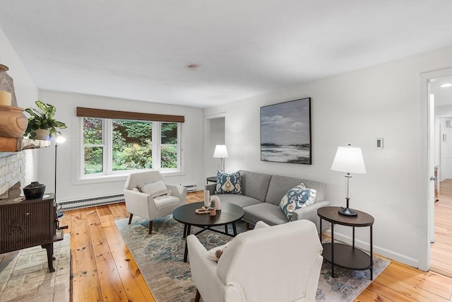 41 Harvey Ln, Westborough, MA 01581 - living area with a baseboard heating unit, light wood-style floors, and a fireplace