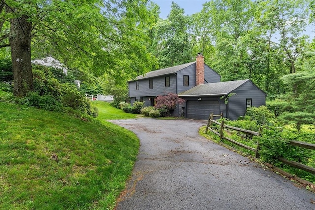 41 Harvey Ln, Westborough, MA 01581 - view of front facade with driveway, a chimney, an attached garage, and a front lawn