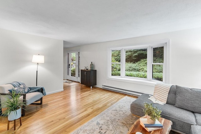 41 Harvey Ln, Westborough, MA 01581 - living room featuring a baseboard heating unit and light wood-type flooring