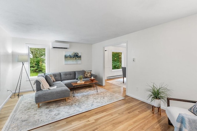 41 Harvey Ln, Westborough, MA 01581 - living area with an AC wall unit, a baseboard heating unit, plenty of natural light, and light wood finished floors