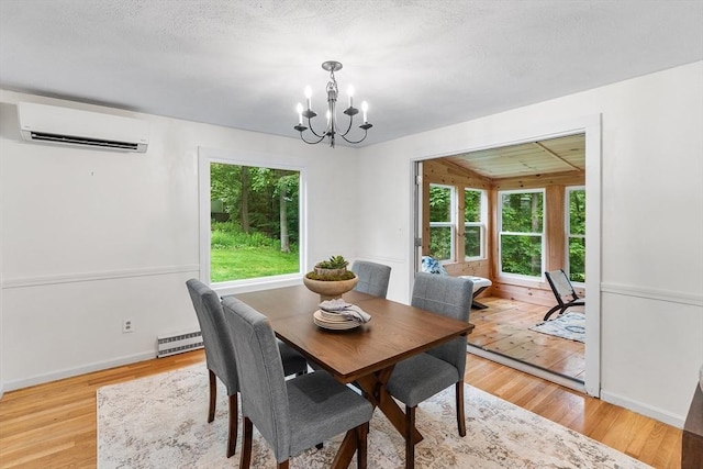 41 Harvey Ln, Westborough, MA 01581 - dining space with a wall mounted AC, a chandelier, light wood finished floors, and baseboard heating