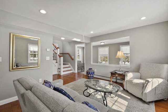 living area with recessed lighting, stairway, baseboard heating, wood finished floors, and baseboards