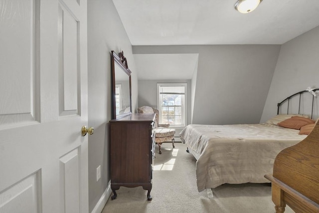 bedroom featuring light colored carpet and baseboards