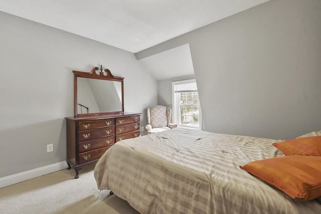 bedroom featuring carpet flooring, vaulted ceiling, and baseboards