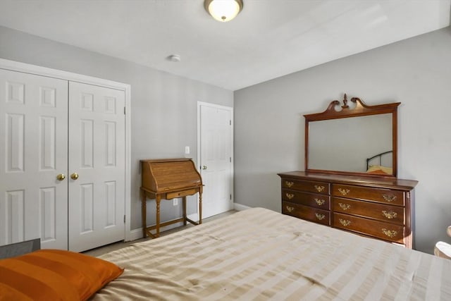 bedroom featuring baseboards and a closet