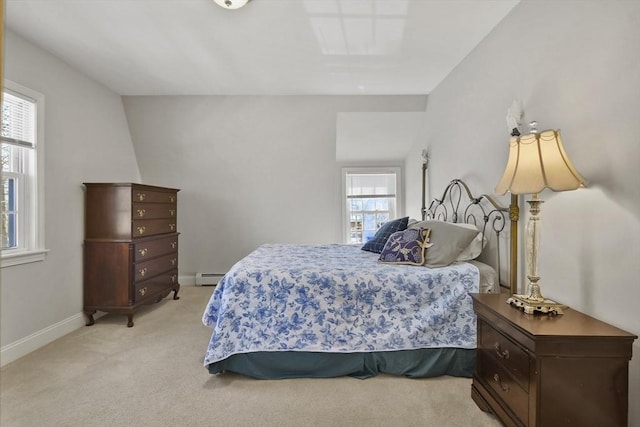 bedroom with light carpet, a baseboard radiator, and baseboards