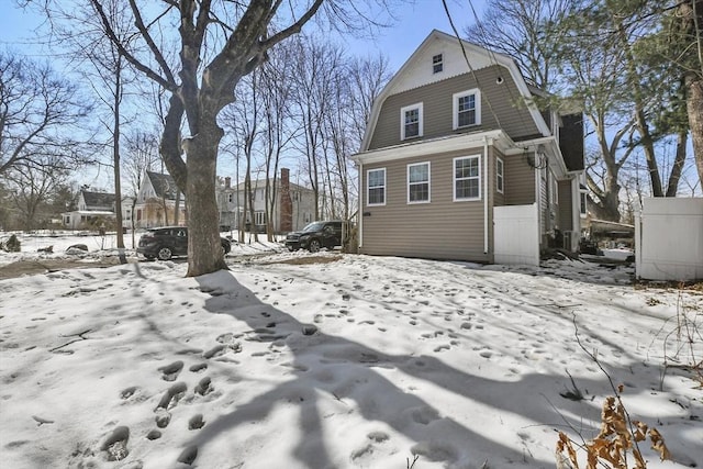 view of snow covered exterior with a gambrel roof