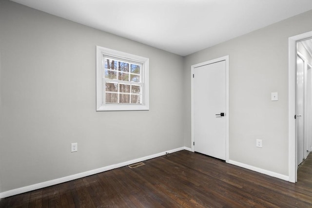 empty room featuring dark wood-type flooring