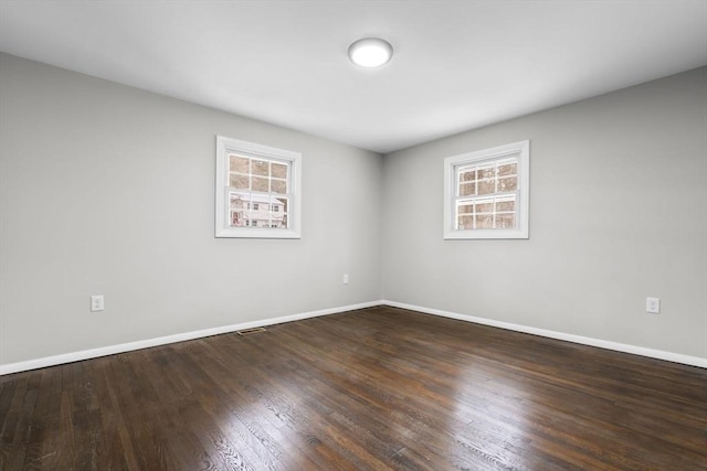 empty room with dark hardwood / wood-style floors