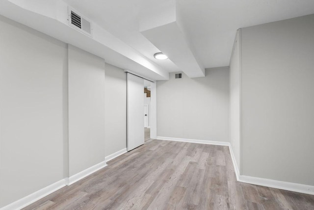 basement with light hardwood / wood-style floors