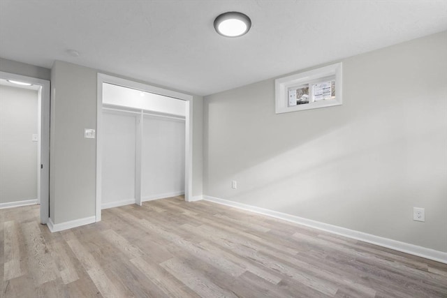 unfurnished bedroom featuring a closet and light hardwood / wood-style flooring