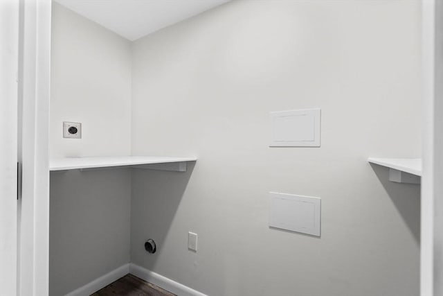 laundry room with electric dryer hookup and dark hardwood / wood-style flooring