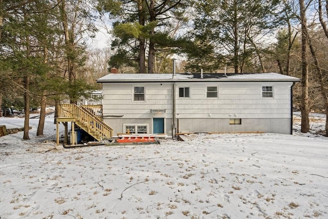 view of snow covered rear of property