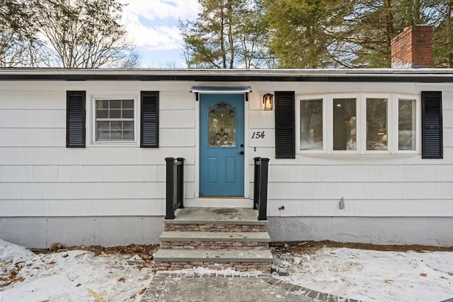 view of snow covered property entrance